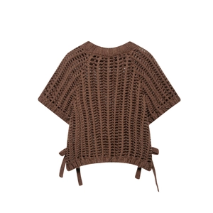 Détail du haut en tricot crochet marron foncé avec texture ajourée et liens latéraux