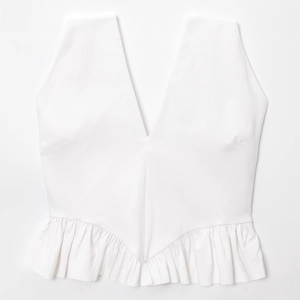 Chic summer white sleeveless halter peplum top with deep V-neck and ruffle hem