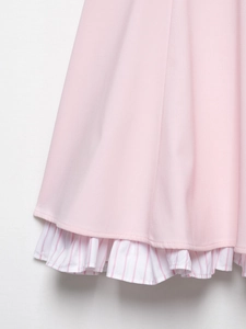 Close-up of pink dress hem featuring delicate white and pink striped ruffle trim details