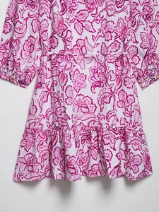 Detail view of pink floral print dress with waist tie and delicate ruffle hemline