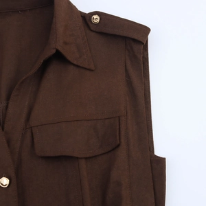 Detail view of the brown sleeveless dress with shoulder epaulettes and gold buttons