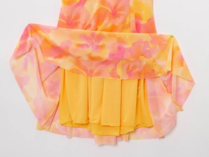 Detail of layered summer dress with floral mesh overlay and bright yellow lining