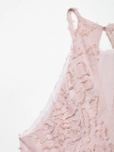 Close-up of pink halter dress with unique textured jacquard floral fringe detail
