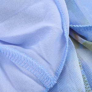 Close-up of light blue mesh fabric showing fine grid texture and neat overlock stitching