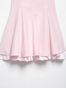 Close-up of pink dress hem featuring sweet white and red striped ruffled layering