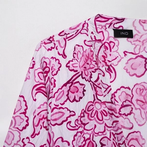 Women's V-neck floral print dress with soft pink patterns and breathable fabric detail