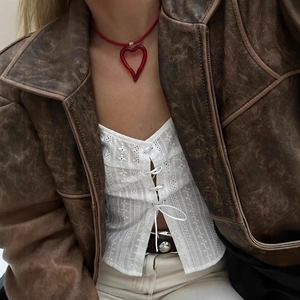 Retro red hollow heart pendant necklace with matching cord on model wearing leather jacket