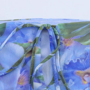 Close-up of mesh fabric featuring blue and purple floral prints and drawstring detail