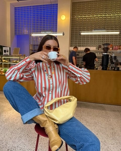 Vertical blue and red striped puff sleeve shirt styled with vibrant yellow leather handbag