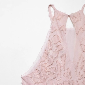 Elegant halter neck dress in light pink with jacquard fringe and open back detail