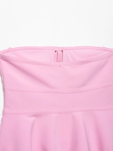 Detail of pink tube top featuring triple horizontal stitching and textured fabric