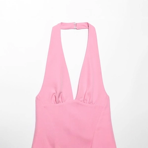 Elegant pink halter dress with deep V-neck and pleats, featuring back button closure
