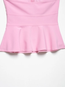 Detail view of the pink peplum hem and decorative topstitching on summer bustier top
