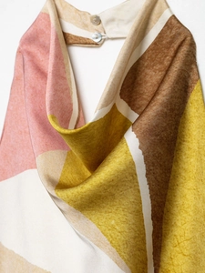 Detail of silk fabric texture with geometric pattern and white shell buttons close-up