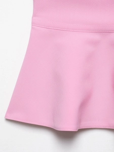 Detailed close-up of pink tube top hem featuring ruffled edges and neat double stitching
