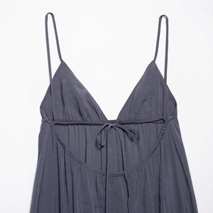 Elegant summer V-neck dark grey slip dress with thin straps and delicate tie detail