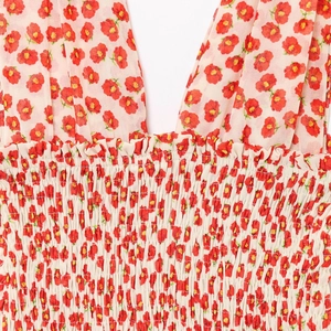 Floral backless mini dress in cream with red poppy print and smocked V-neckline
