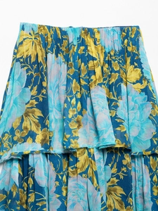 Detailed close-up of tiered skirt layers featuring vintage blue and yellow floral prints