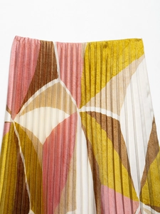 Detail of geometric pleated midi skirt with brown, yellow and pink block patterns