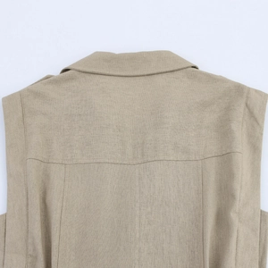 Macro detail of beige linen texture with vertical seams and clean stitching on sleeveless dress
