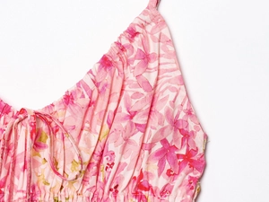 Close-up of pink floral print summer dress with gathered neckline and tie-up bow detail