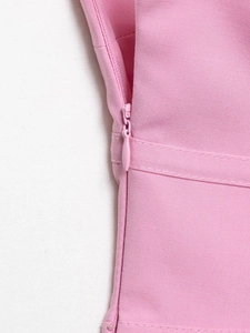 Close-up of pink tube top showing invisible side zipper and premium stitching details