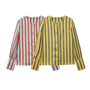 Close-up of classic vertical wide stripes with covered buttons on women's cotton blouses