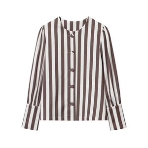 Detail of vertical brown and white striped shirt with puff sleeves and button closure