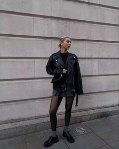 Classic black faux leather biker jacket with metallic zippers and adjustable belt detail