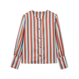 Detail of red and blue vertical striped shirt showing button closure and puffed sleeves