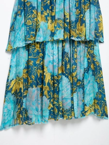 Close-up of layered blue floral dress featuring raw edge ruffles and lightweight fabric