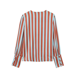 Detail of striped shirt sleeve with orange and blue patterns and four side buttons