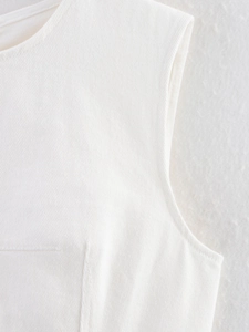 Detail of white sleeveless top showing fine diagonal twill fabric and neat round neckline