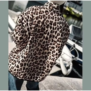 Detailed back view of women's leopard print jacket featuring diamond quilted stitching patterns