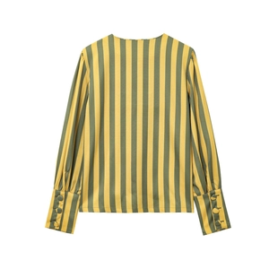 Detail view of the back of a yellow and green striped blouse with three-button cuffs