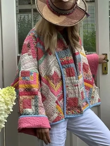 Close-up of bohemian patchwork quilted jacket with vibrant patterns and oversized cuffs