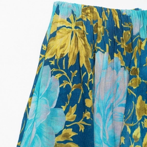 Women's strapless summer dress featuring blue floral print and pleated fabric texture