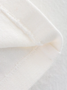 Detailed close-up of premium twill fabric texture and high-quality edge stitching seams