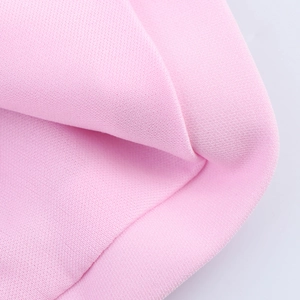 Detail shot of the pink knit fabric showing high-quality stitching and soft texture