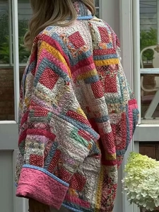 Close-up of patchwork quilted jacket featuring vibrant patterns and detailed stitching texture