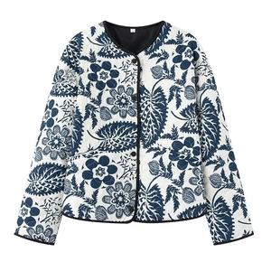Detailed view of lightweight quilted jacket with dark blue floral print and black piping