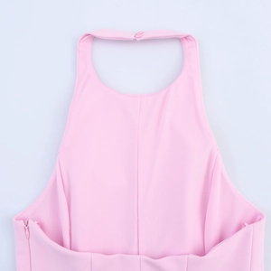 Detailed back view of a light pink halter neck top featuring buttons and a side zipper