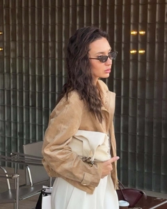 Detail of camel faux suede jacket with notched lapel and cuff strap for a chic urban look