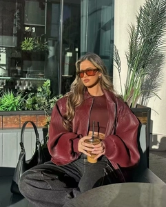 Detail of burgundy pleated texture jacket with dropped shoulder and zip-up collar