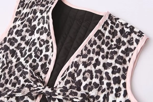 Dettaglio del gilet trapuntato leopardato con profili rosa e chiusura a fiocco