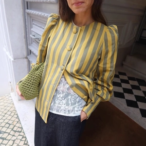 Vintage striped blazer with puff sleeves and matching buttons worn with a green crochet bag