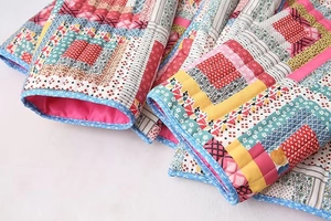 Detail of quilted jacket sleeve featuring patchwork patterns and floral print edging