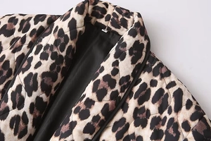 Detail shot of leopard print quilted jacket with diamond patterns and sleek black lining