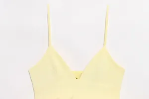 Detail shot of light yellow camisole showing thin spaghetti straps and clean V-neckline