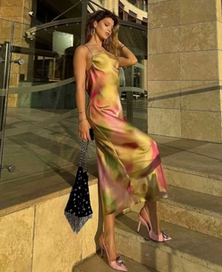 Detailed close-up of colorful abstract watercolor print on satin backless maxi dress